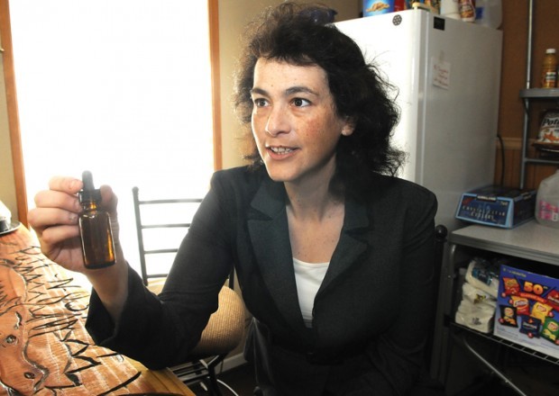 Sheri Levit with a bottle of liquid tincture of cannabis. One of the centers goals is to teach people about the healing benefits of cannabis without smoking it because, she says, smoke in any form is dangerous to ones health. (photo by Mark Ylen/Democrat-Herald)
